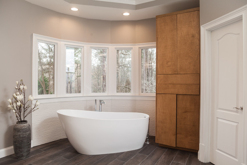 Freestanding bathtub - large modern master white tile and porcelain tile porcelain tile and gray floor freestanding bathtub idea in Atlanta with flat-panel cabinets, light wood cabinets, a one-piece toilet, gray walls, a vessel sink, quartzite countertops, a hinged shower door and white countertops