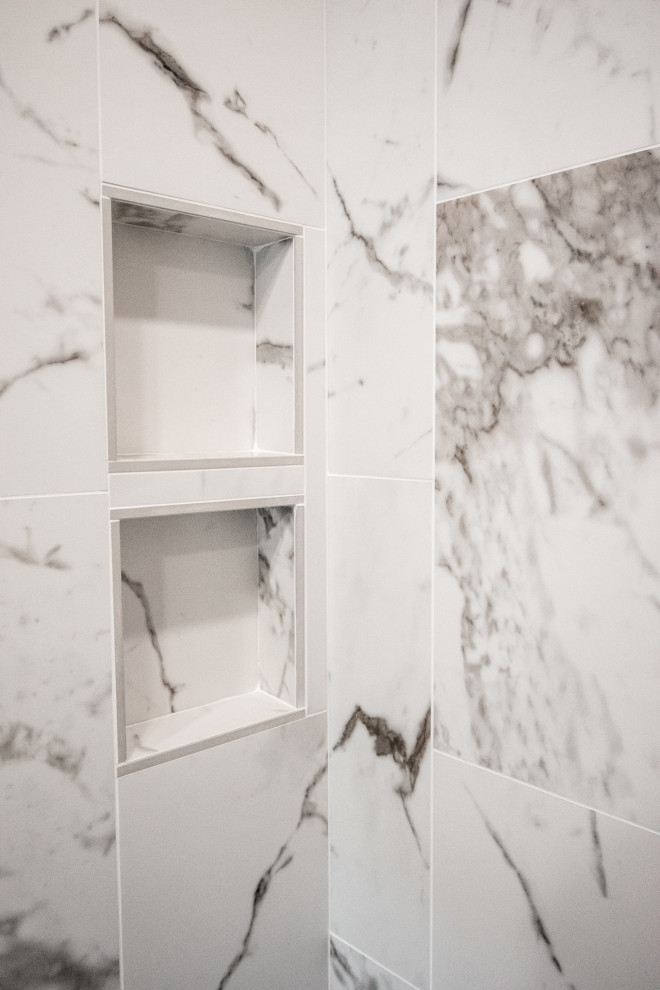Inredning av ett modernt mellanstort vit vitt en-suite badrum, med släta luckor, svarta skåp, en dusch i en alkov, en vägghängd toalettstol, vit kakel, porslinskakel, grå väggar, klinkergolv i porslin, ett undermonterad handfat, bänkskiva i kvarts, grått golv och dusch med gångjärnsdörr
