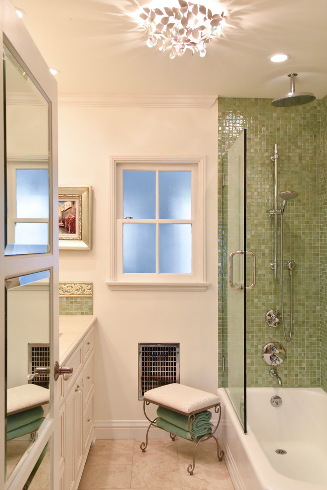 Inspiration for a large mediterranean master green tile and glass tile porcelain tile bathroom remodel in Los Angeles with an undermount sink, recessed-panel cabinets, distressed cabinets, solid surface countertops, a one-piece toilet and beige walls
