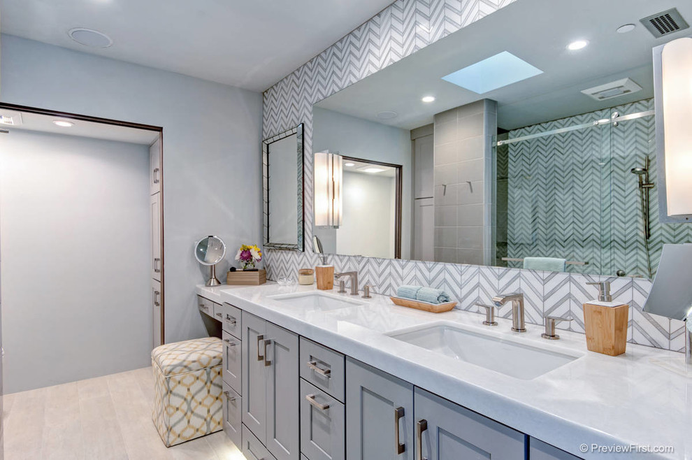 Walk-in shower - mid-sized modern master gray tile and stone tile porcelain tile walk-in shower idea in San Diego with an undermount sink, shaker cabinets, gray cabinets, marble countertops, a one-piece toilet and gray walls