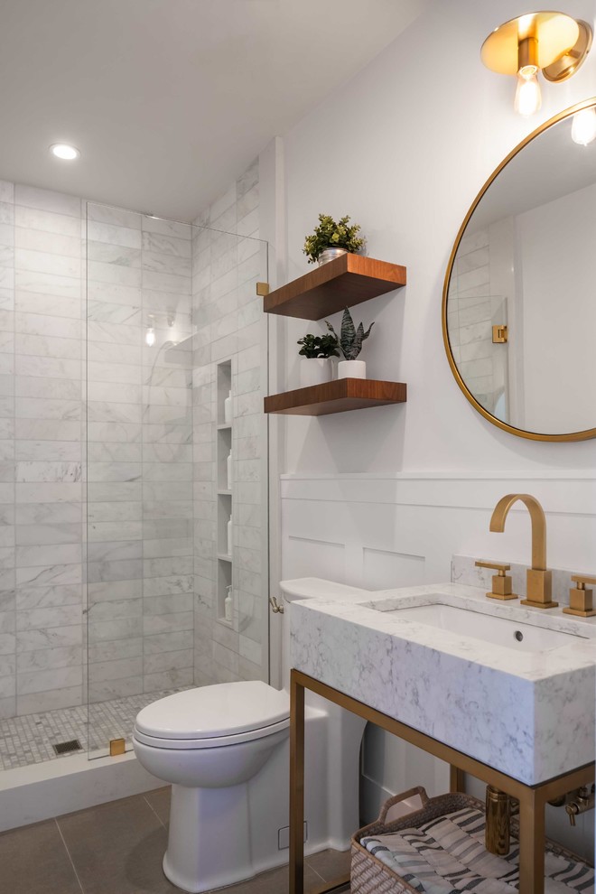 Inspiration for a small modern 3/4 white tile and marble tile porcelain tile and brown floor alcove shower remodel in Los Angeles with a one-piece toilet, white walls, marble countertops, a hinged shower door, white countertops, open cabinets, white cabinets and a console sink