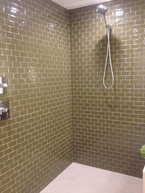 Inspiration for a large traditional shower room bathroom in Minneapolis with a built-in sink, flat-panel cabinets, medium wood cabinets, quartz worktops, an alcove bath, brown tiles, porcelain tiles, beige walls and porcelain flooring.
