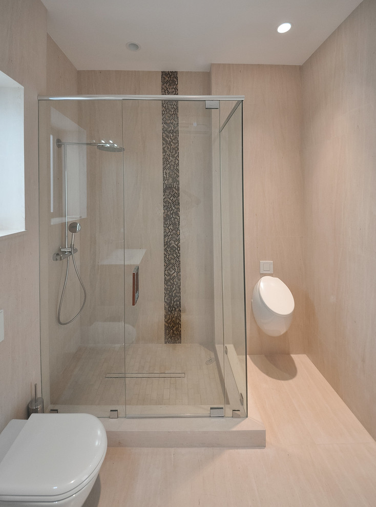 Example of a trendy beige tile and stone tile doorless shower design in Miami with a wall-mount toilet
