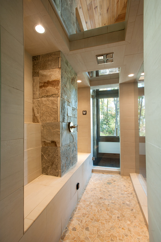 Photo of a rustic bathroom in Charlotte with pebble tile flooring.