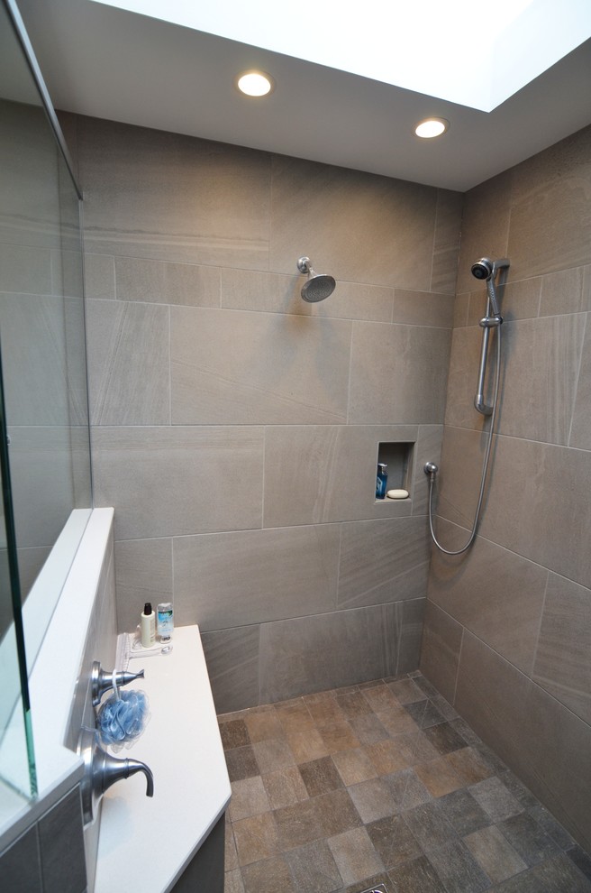 Large trendy master gray tile and porcelain tile porcelain tile bathroom photo in Other with an undermount sink, recessed-panel cabinets, dark wood cabinets, quartz countertops, a two-piece toilet and gray walls