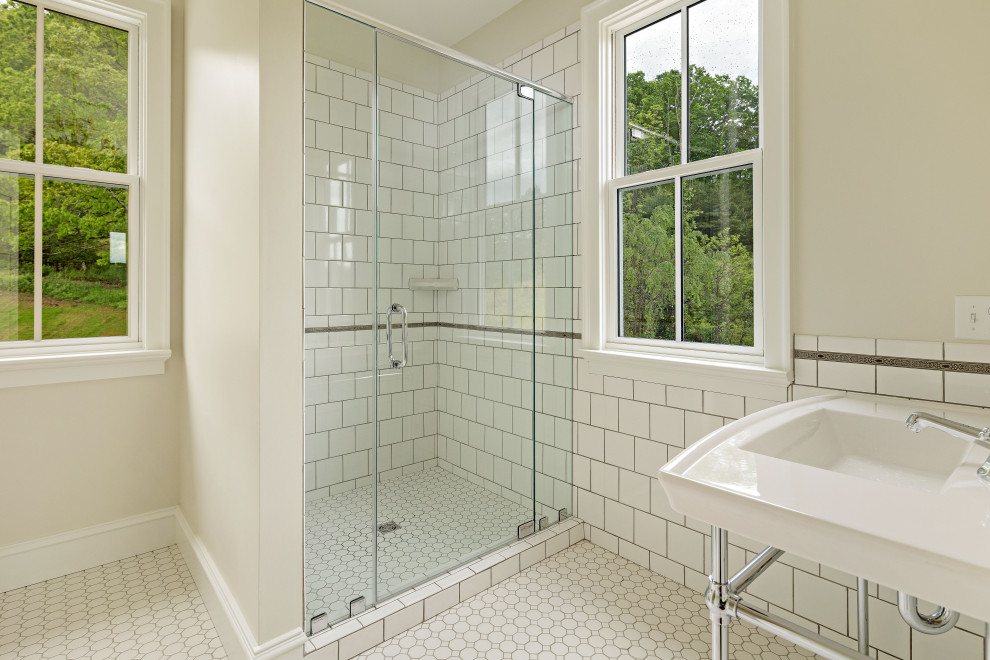 На фото: главная ванная комната среднего размера в стиле кантри с белыми фасадами, отдельно стоящей ванной, угловым душем, унитазом-моноблоком, белой плиткой, керамогранитной плиткой, белыми стенами, полом из керамогранита, раковиной с пьедесталом, столешницей из гранита, белым полом, душем с распашными дверями, белой столешницей, тумбой под две раковины и напольной тумбой