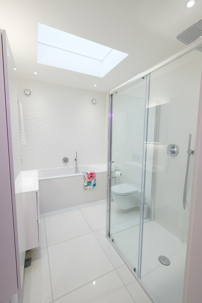 Exempel på ett litet modernt en-suite badrum, med en dubbeldusch, en vägghängd toalettstol, porslinskakel, vita väggar, klinkergolv i porslin, ett väggmonterat handfat, vitt golv och dusch med gångjärnsdörr