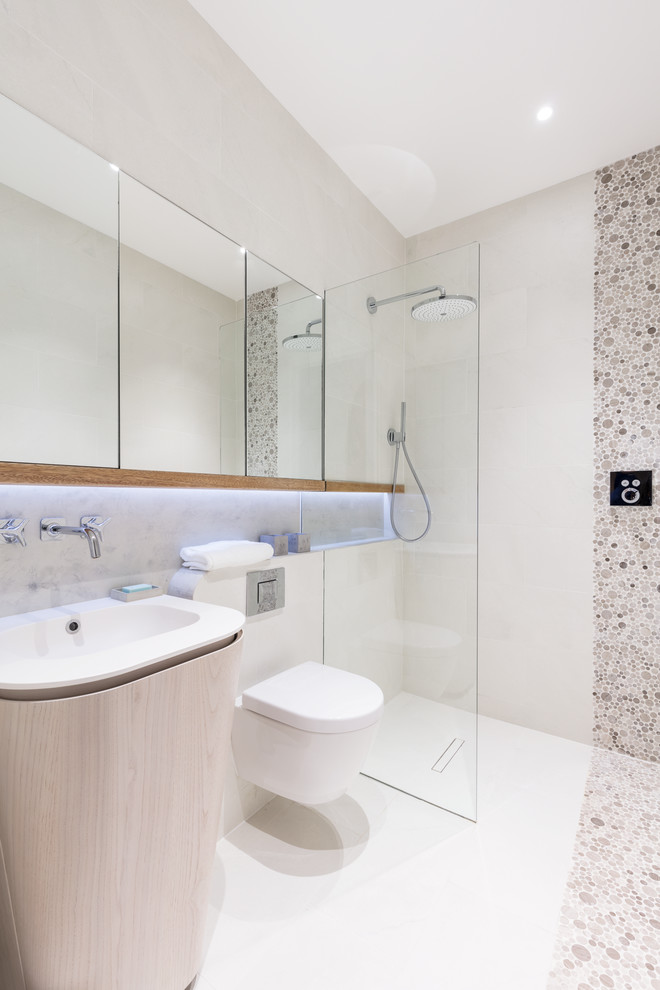 Photo of a medium sized modern shower room bathroom in London with open cabinets, an alcove shower, a wall mounted toilet, ceramic tiles, beige walls, mosaic tile flooring and a console sink.