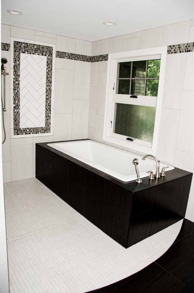 Photo of a large contemporary ensuite bathroom in Detroit with recessed-panel cabinets, brown cabinets, a built-in bath, a built-in shower, white tiles, porcelain tiles, white walls, porcelain flooring, a submerged sink, engineered stone worktops, white floors and multi-coloured worktops.