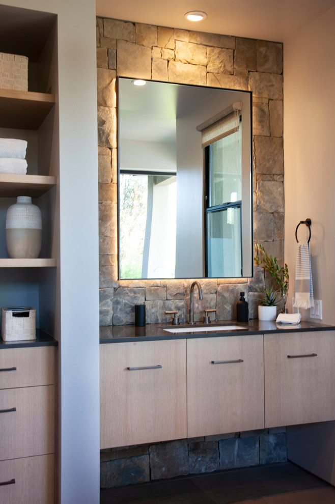 Photo of a large contemporary shower room bathroom in San Diego with flat-panel cabinets, a submerged bath, grey tiles, stone tiles, white walls, concrete flooring, a vessel sink, engineered stone worktops, grey floors and black worktops.