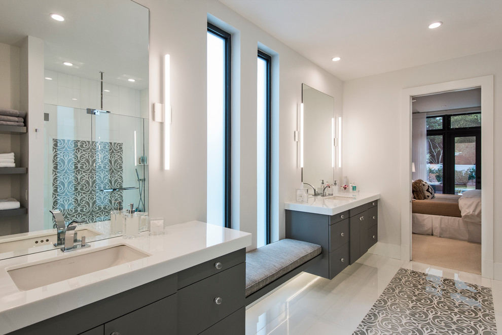 This is an example of a contemporary bathroom in Miami with a submerged sink, flat-panel cabinets, dark wood cabinets, engineered stone worktops, a built-in shower, white tiles and white walls.