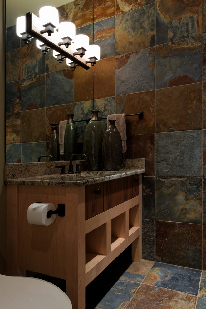 Photo of an expansive contemporary shower room bathroom in Omaha with a submerged sink, flat-panel cabinets, light wood cabinets, granite worktops, multi-coloured tiles, stone tiles and slate flooring.