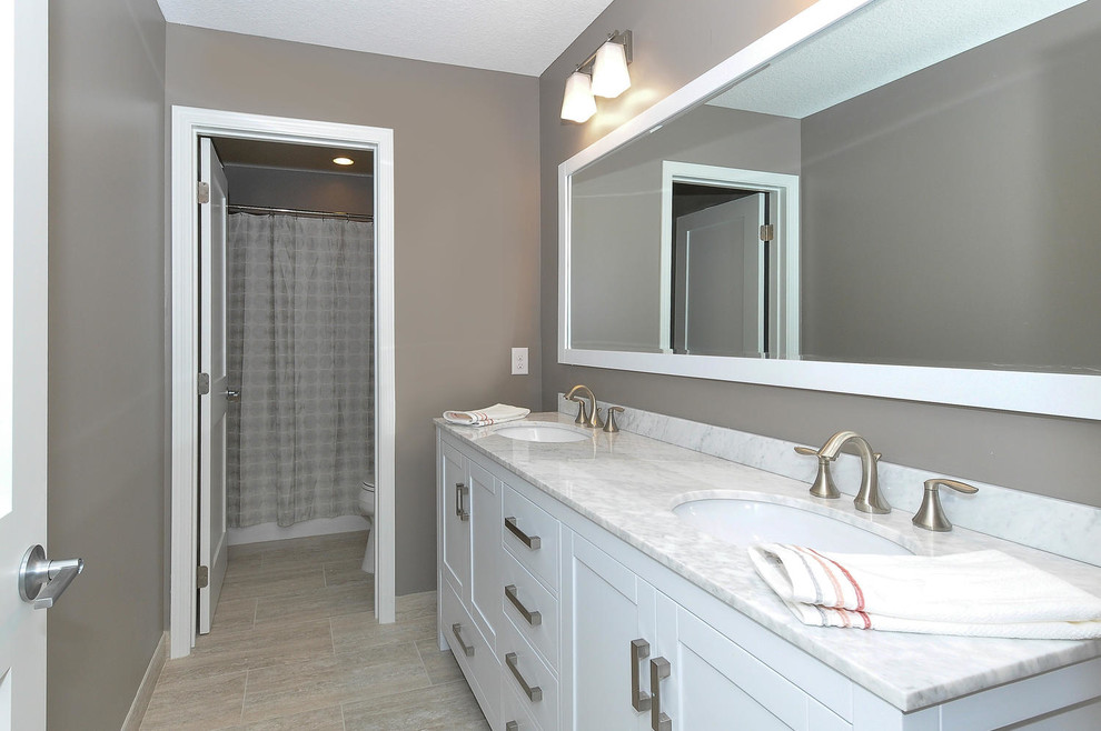 Mid-sized transitional master porcelain tile and beige floor bathroom photo in Minneapolis with shaker cabinets, white cabinets, beige walls, an undermount sink, quartz countertops and white countertops