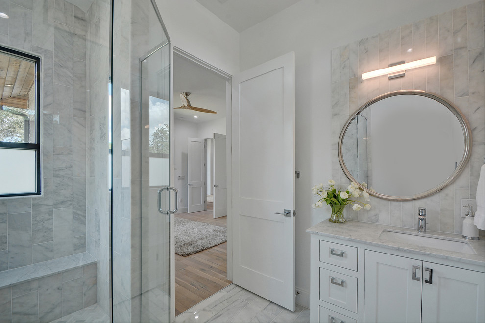 Example of a mid-sized transitional double shower design in Nashville with shaker cabinets, white cabinets, marble countertops, a one-piece toilet, white walls and an undermount sink