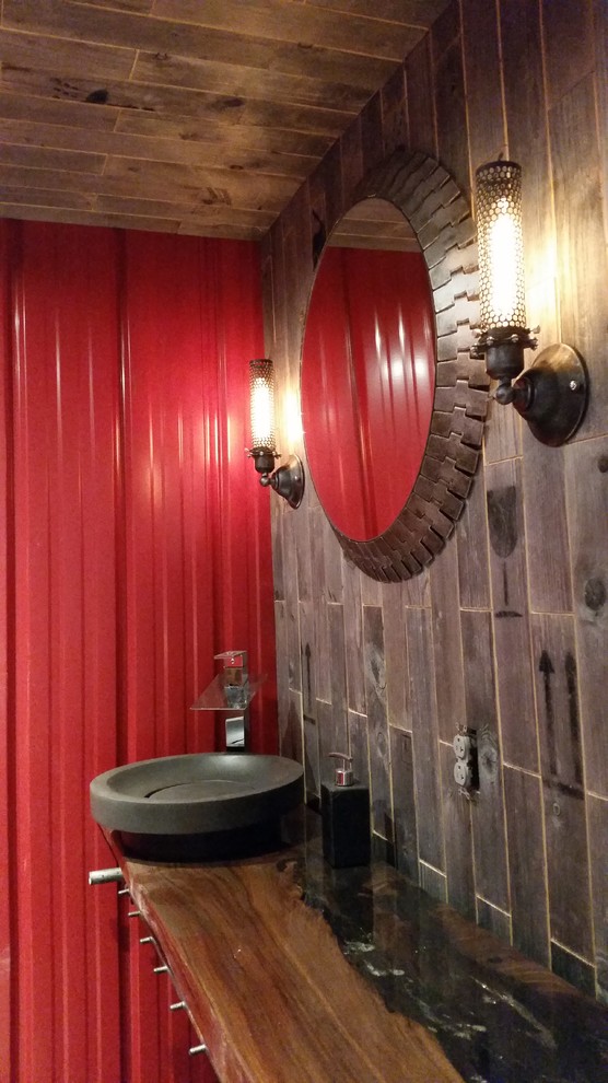 Photo of a medium sized industrial bathroom in Cleveland with a two-piece toilet, grey tiles, red walls, dark hardwood flooring and a vessel sink.