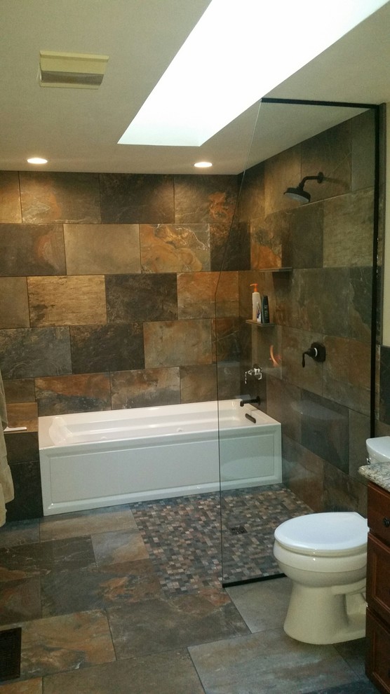 This is an example of a medium sized rustic bathroom in Seattle with a freestanding bath, a built-in shower, multi-coloured tiles, porcelain tiles and porcelain flooring.