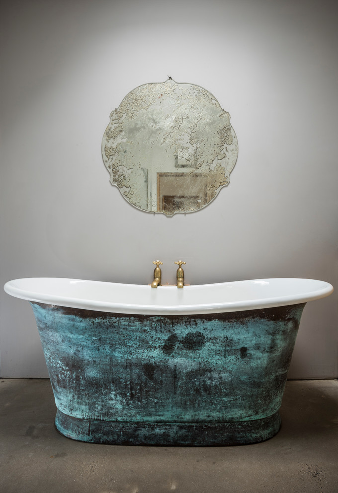 This is an example of a rustic bathroom in Dorset with a freestanding bath.