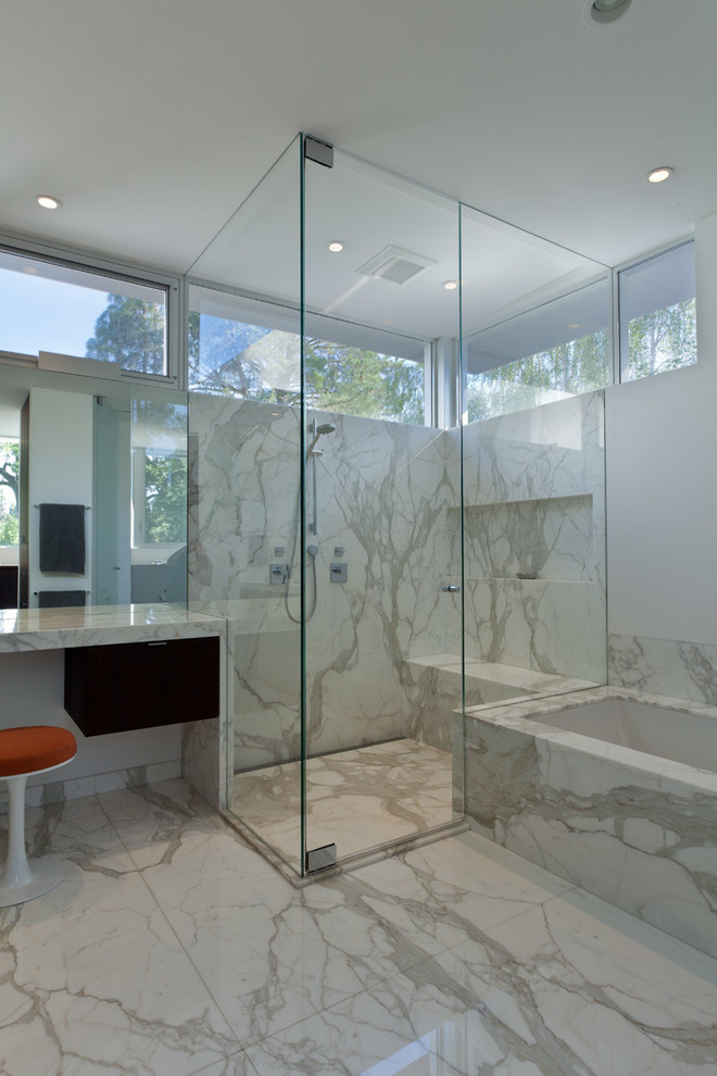 Inspiration for a modern white tile corner shower remodel in San Francisco with an undermount sink, flat-panel cabinets and dark wood cabinets