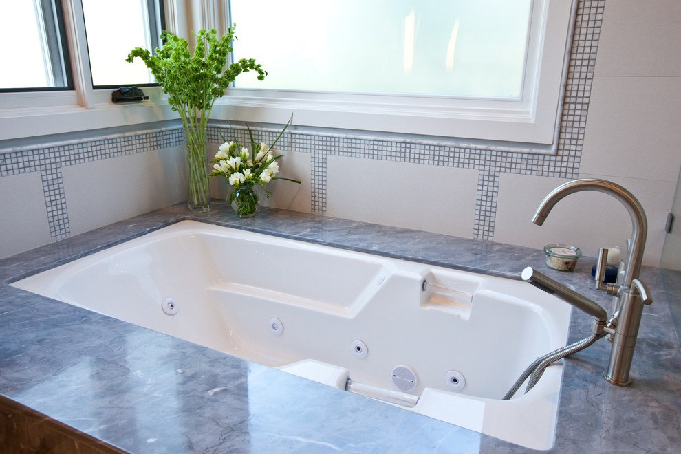 Bild på ett mellanstort funkis en-suite badrum, med släta luckor, vita skåp, ett undermonterat badkar, en dusch i en alkov, grå kakel, porslinskakel, grå väggar, klinkergolv i porslin, ett undermonterad handfat, marmorbänkskiva, grått golv och dusch med gångjärnsdörr