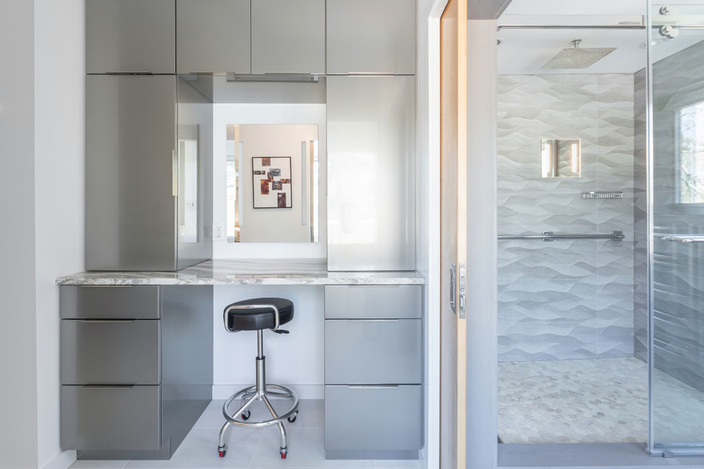 Свежая идея для дизайна: ванная комната в современном стиле с белыми фасадами, душем в нише, белой плиткой, керамической плиткой, бежевыми стенами, полом из галечной плитки, настольной раковиной, столешницей из искусственного камня, разноцветным полом, душем с раздвижными дверями и белой столешницей - отличное фото интерьера