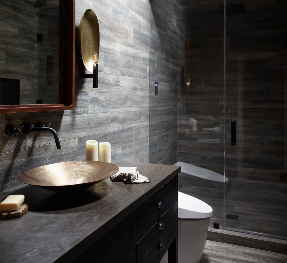 Example of a mid-sized mountain style black tile and ceramic tile ceramic tile and black floor wet room design in San Francisco with black cabinets, a bidet, black walls, a vessel sink, granite countertops and a hinged shower door