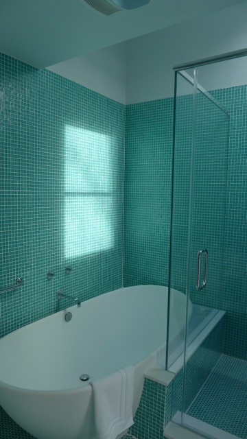 Großes Modernes Badezimmer mit Wandwaschbecken, Glasfronten, weißen Schränken, Mineralwerkstoff-Waschtisch, freistehender Badewanne, Wandtoilette, Glasfliesen und weißer Wandfarbe in New York