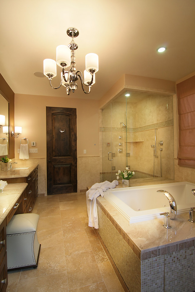 Inspiration pour une grande salle de bain principale méditerranéenne en bois brun avec une baignoire posée, WC à poser, un carrelage beige, un mur beige, un sol en travertin, un lavabo encastré, un plan de toilette en marbre et une douche d'angle.