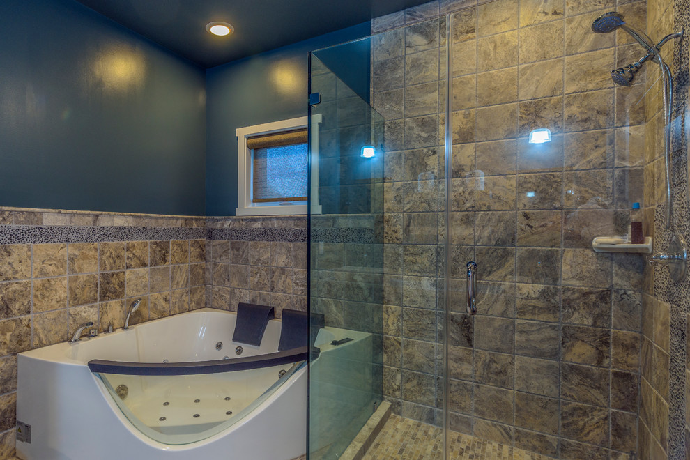 Photo of a medium sized bohemian ensuite bathroom in DC Metro with a hot tub, a corner shower, brown tiles, pebble tiles, blue walls, porcelain flooring, a vessel sink, tiled worktops, flat-panel cabinets, medium wood cabinets, beige floors and a hinged door.