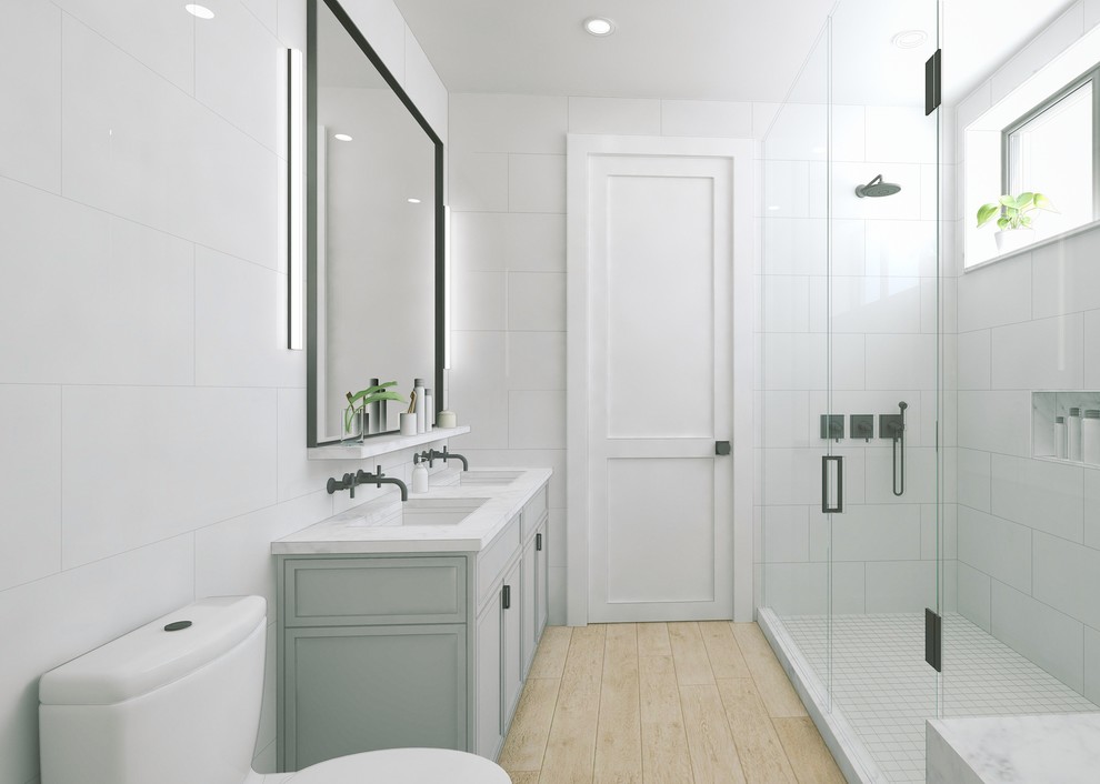 Cette photo montre une grande salle de bain principale moderne avec un placard avec porte à panneau encastré, un plan de toilette en marbre, un carrelage blanc, des carreaux de porcelaine, une douche ouverte, WC suspendus, un mur blanc, parquet clair, des portes de placard grises et un lavabo encastré.