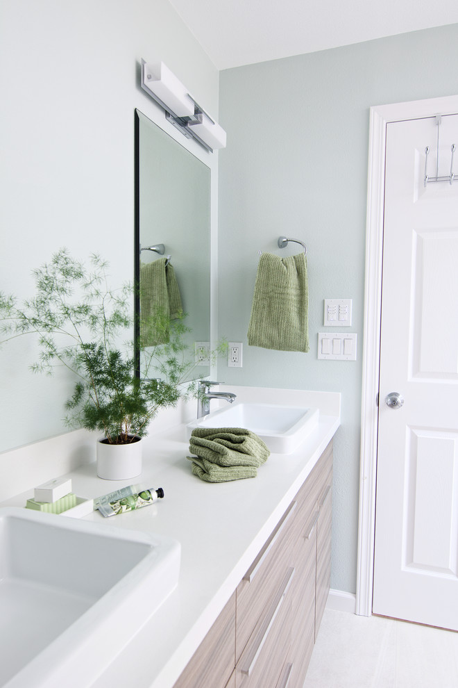Inspiration for a mid-sized modern master beige tile and porcelain tile porcelain tile bathroom remodel in Seattle with flat-panel cabinets, light wood cabinets, a one-piece toilet, green walls, a vessel sink and quartz countertops