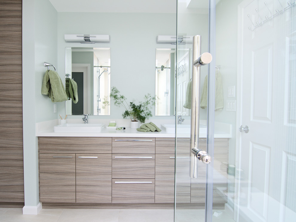 Design ideas for a medium sized modern ensuite bathroom in Seattle with flat-panel cabinets, light wood cabinets, a built-in bath, a double shower, a one-piece toilet, beige tiles, porcelain tiles, green walls, porcelain flooring, a vessel sink and engineered stone worktops.
