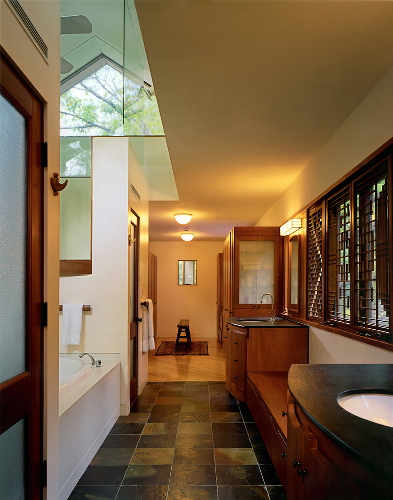 This is an example of a contemporary bathroom in Boston with a submerged sink, medium wood cabinets, an alcove shower, black tiles and flat-panel cabinets.