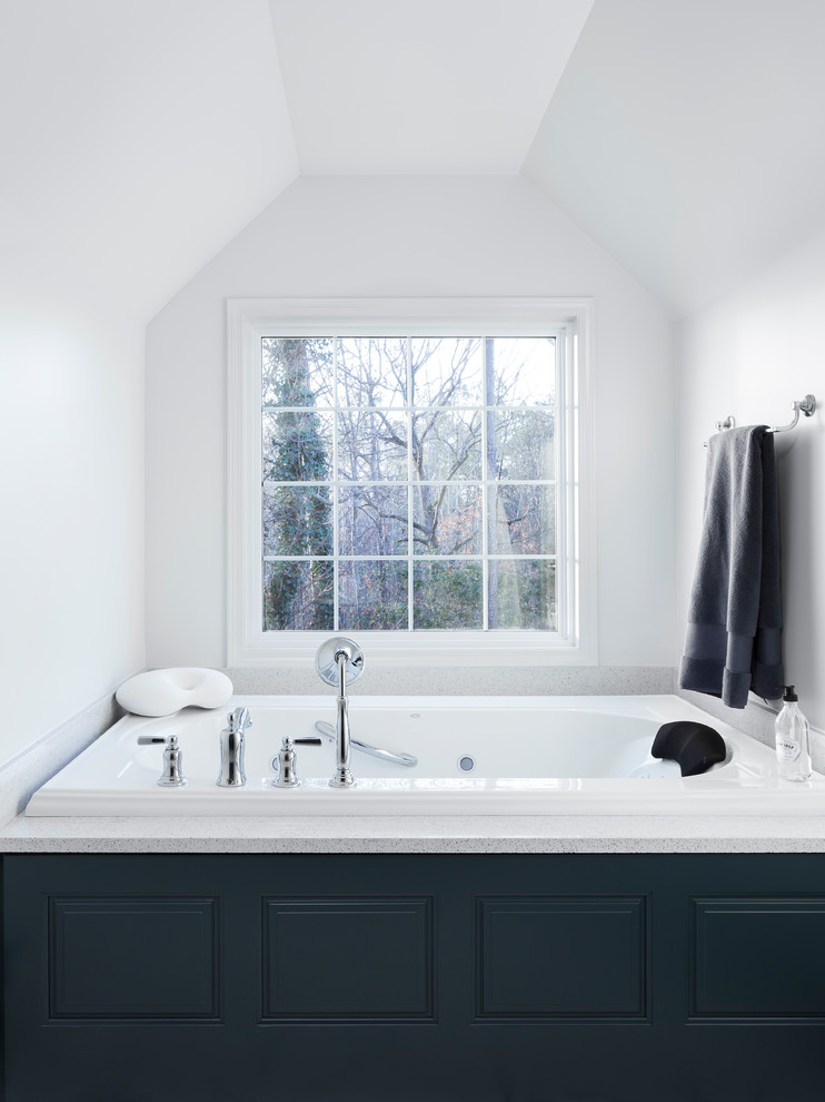 Inspiration for a large modern ensuite bathroom in Birmingham with raised-panel cabinets, blue cabinets, a hot tub, a built-in shower, a one-piece toilet, white tiles, ceramic tiles, white walls, ceramic flooring, a built-in sink, quartz worktops, white floors and a hinged door.