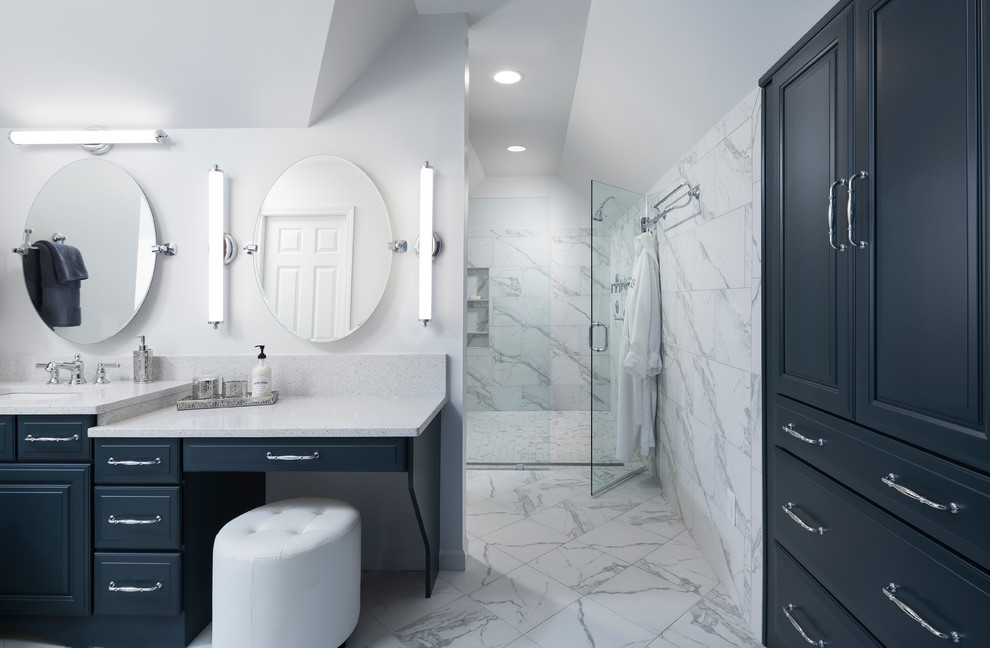 This is an example of a large traditional ensuite bathroom in Birmingham with raised-panel cabinets, blue cabinets, a hot tub, a built-in shower, a one-piece toilet, white tiles, ceramic tiles, white walls, ceramic flooring, a built-in sink, quartz worktops, white floors and a hinged door.