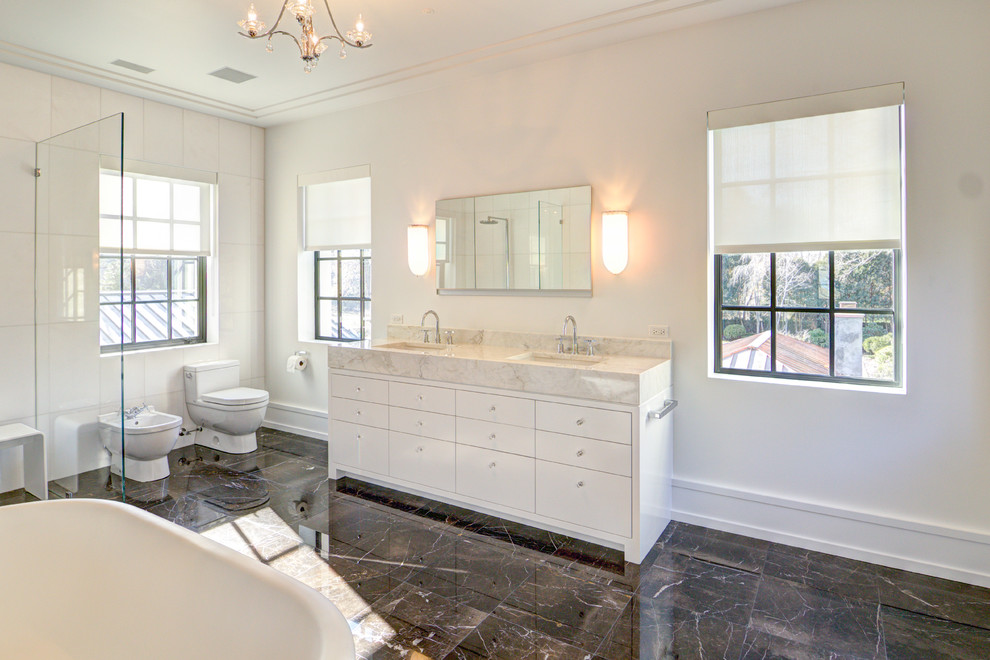 Inspiration for a large modern master marble floor and brown floor bathroom remodel in Chicago with flat-panel cabinets, white cabinets, a bidet, white walls, an integrated sink and marble countertops