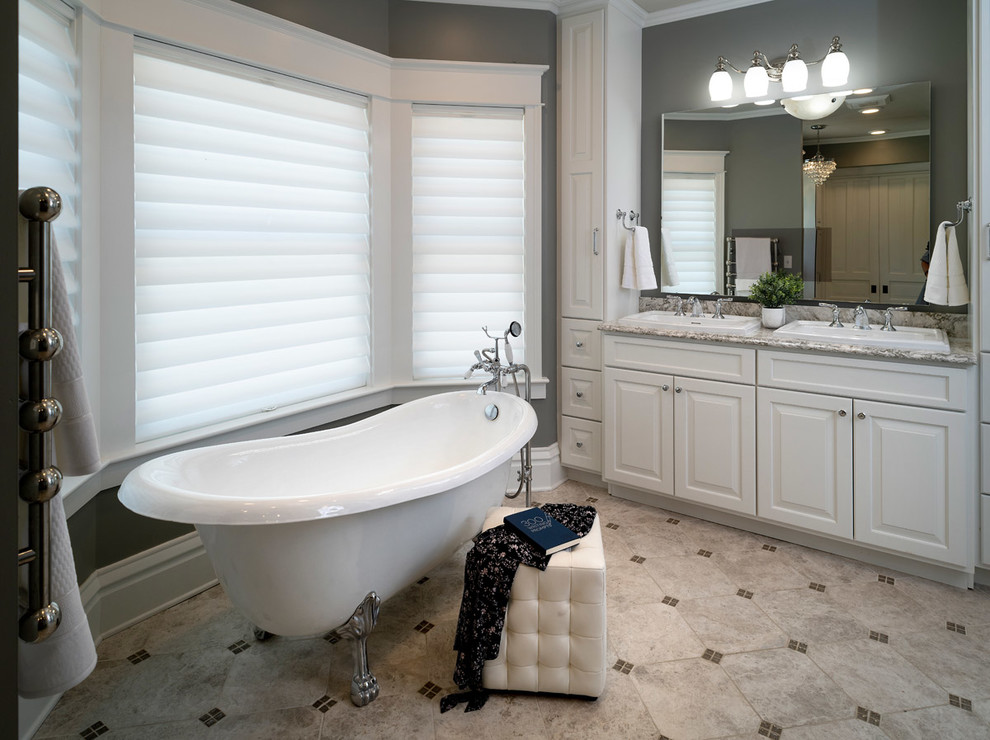 Inspiration for a large victorian master porcelain tile and gray floor claw-foot bathtub remodel in Other with raised-panel cabinets, white cabinets, gray walls, a drop-in sink, quartzite countertops and gray countertops