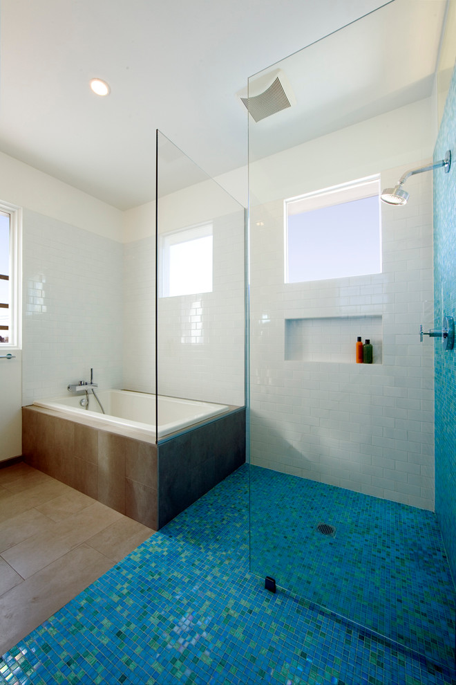 Inspiration for a mid-sized modern master blue tile and glass tile porcelain tile and brown floor bathroom remodel in New York with flat-panel cabinets, medium tone wood cabinets, an integrated sink, concrete countertops, a one-piece toilet and white walls