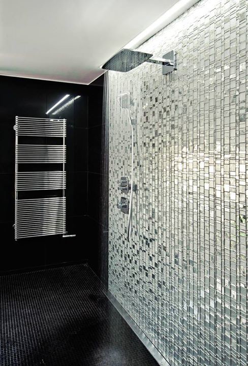 This is an example of a large modern ensuite bathroom in Miami with a walk-in shower, black and white tiles, glass tiles, black walls and mosaic tile flooring.