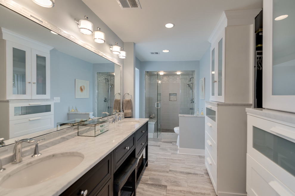 Bathroom - small modern master gray tile and porcelain tile porcelain tile bathroom idea in DC Metro with furniture-like cabinets, dark wood cabinets, a two-piece toilet, blue walls, an undermount sink and marble countertops