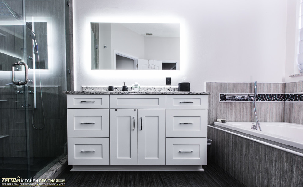 Inredning av ett modernt stort badrum, med luckor med upphöjd panel, vita skåp, bänkskiva i kvarts, ett undermonterad handfat, grå kakel, porslinskakel och klinkergolv i porslin