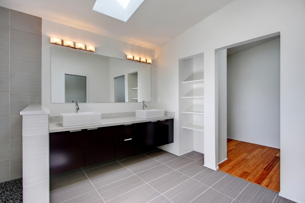 Large modern ensuite bathroom in Seattle with flat-panel cabinets, dark wood cabinets and green tiles.
