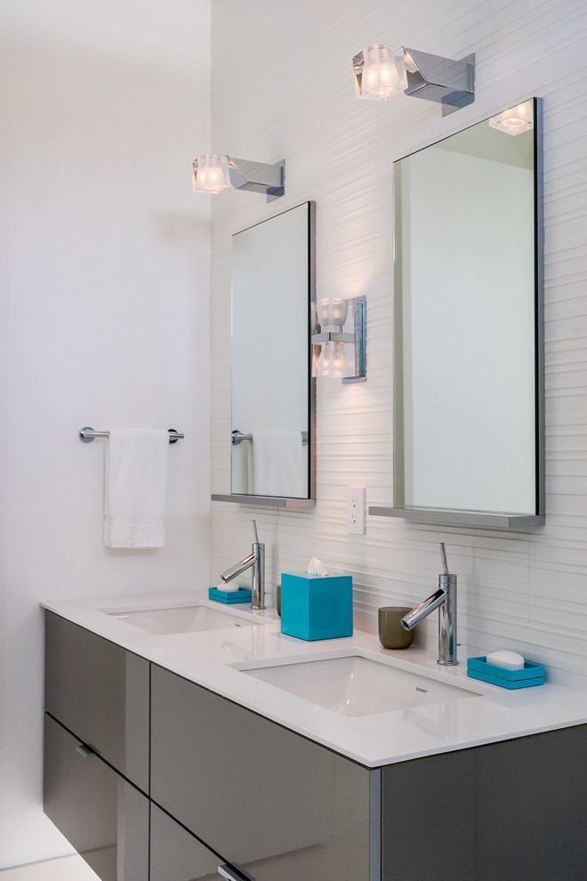 Photo of a large contemporary ensuite bathroom in Miami with a submerged sink, flat-panel cabinets, grey cabinets, solid surface worktops, white walls and porcelain flooring.