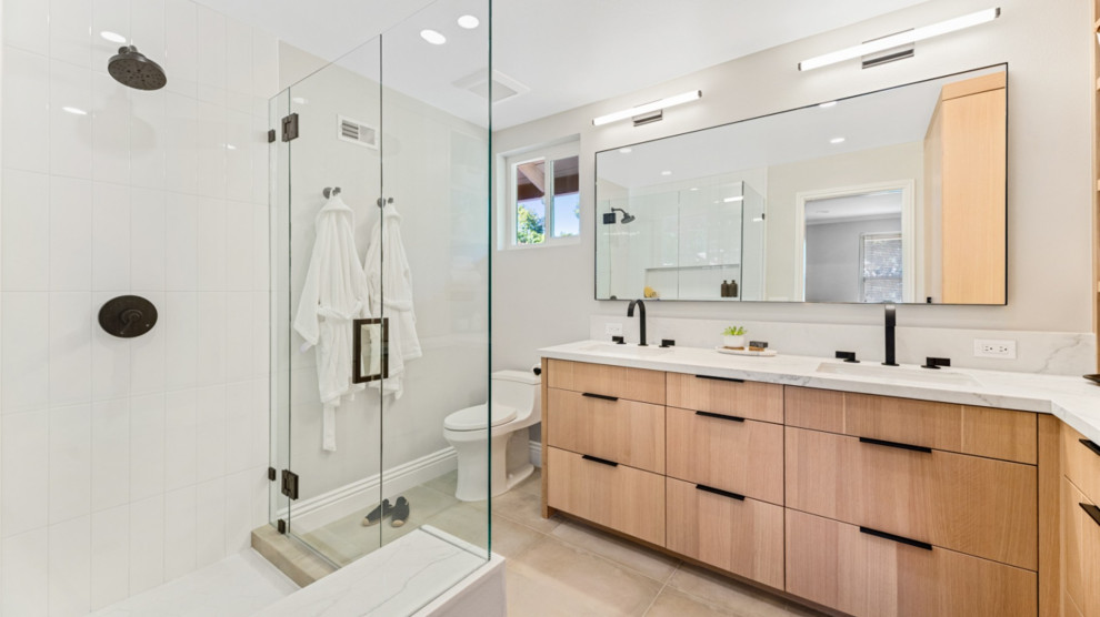 Large minimalist master white tile and porcelain tile porcelain tile and beige floor corner shower photo in Los Angeles with light wood cabinets, a wall-mount toilet, white walls, an undermount sink, quartz countertops and white countertops