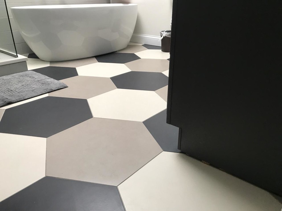 Bathroom - large modern master white tile porcelain tile and multicolored floor bathroom idea in Chicago with gray cabinets, gray walls, an undermount sink, quartz countertops and a hinged shower door