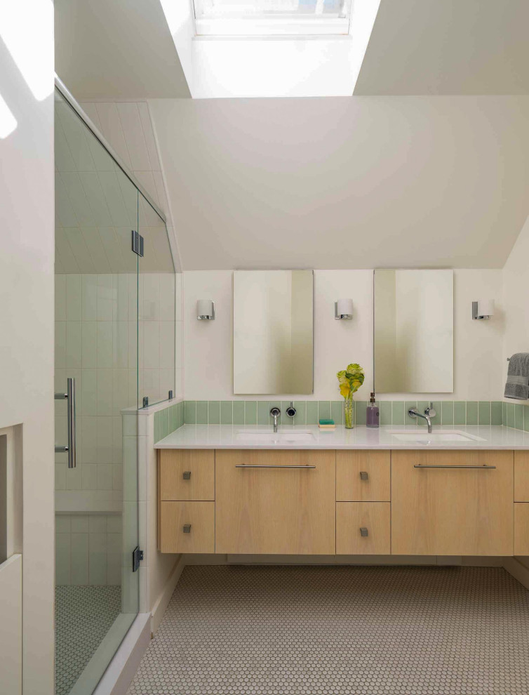 Photo of a contemporary bathroom in Boston with flat-panel cabinets, light wood cabinets, an alcove shower, white walls, mosaic tile flooring, a submerged sink, grey floors, a hinged door, white worktops, double sinks, a floating vanity unit and a vaulted ceiling.