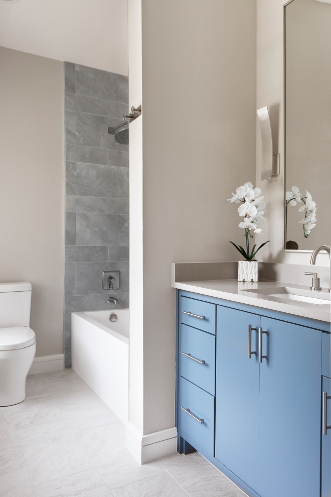Inspiration for a contemporary gray tile and porcelain tile porcelain tile, white floor and single-sink bathroom remodel in Dallas with flat-panel cabinets, blue cabinets, a one-piece toilet, gray walls, an undermount sink, quartz countertops, gray countertops, a niche and a built-in vanity