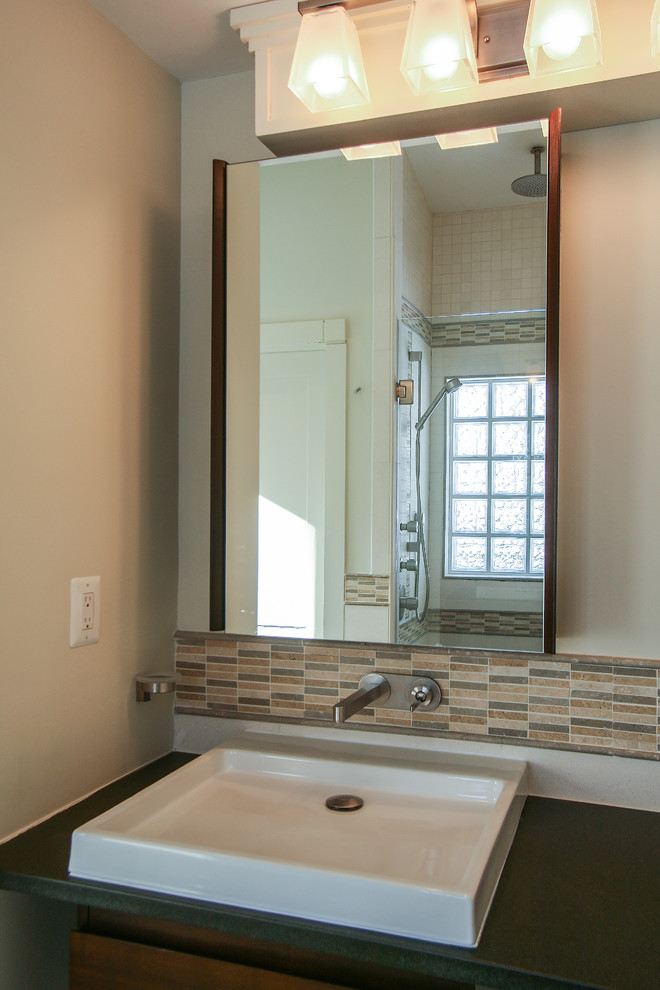 Example of a mid-sized asian brown tile and stone tile limestone floor bathroom design in DC Metro with an undermount sink, flat-panel cabinets, dark wood cabinets, limestone countertops, a two-piece toilet and white walls