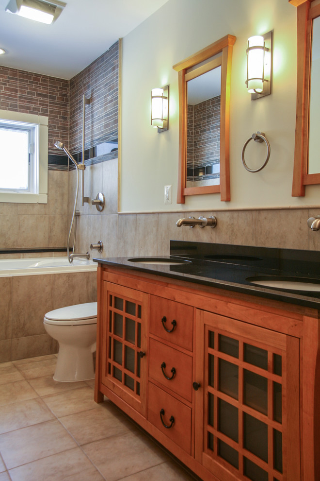 Medium sized world-inspired bathroom in DC Metro with a submerged sink, freestanding cabinets, light wood cabinets, granite worktops, a built-in bath, a shower/bath combination, a two-piece toilet, brown tiles, porcelain tiles, white walls and porcelain flooring.