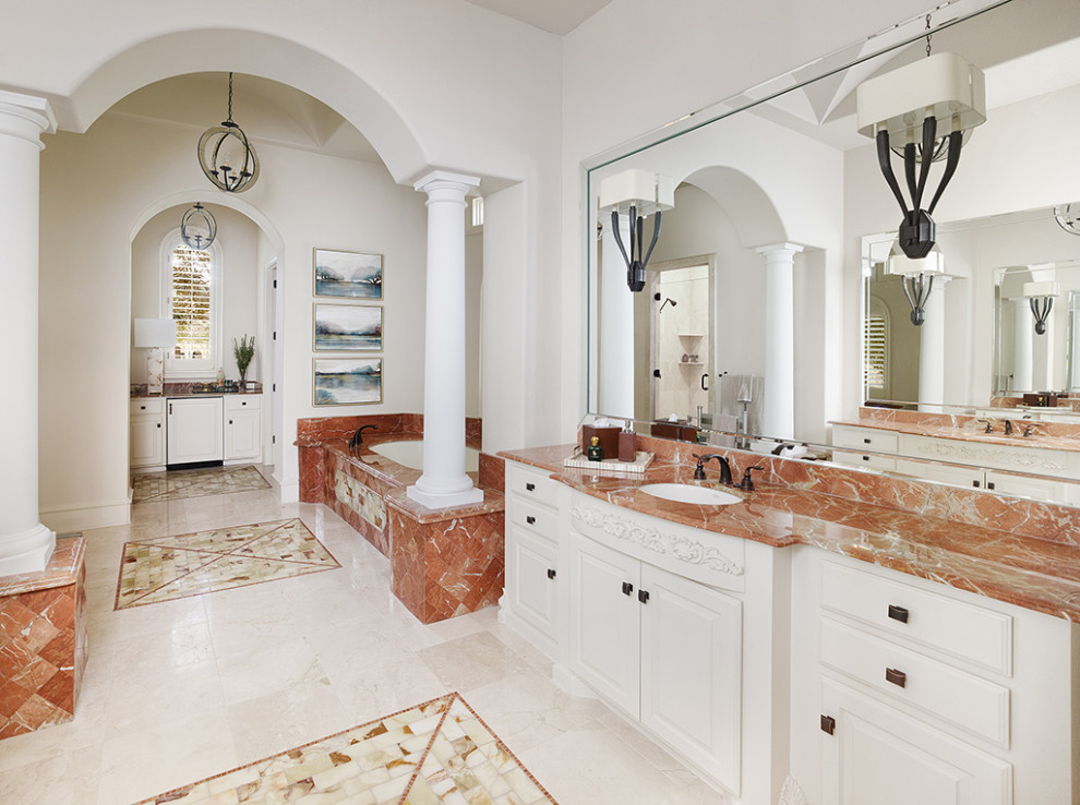 Inspiration for a mediterranean ensuite bathroom in Dallas with white cabinets, a submerged bath and a built in vanity unit.