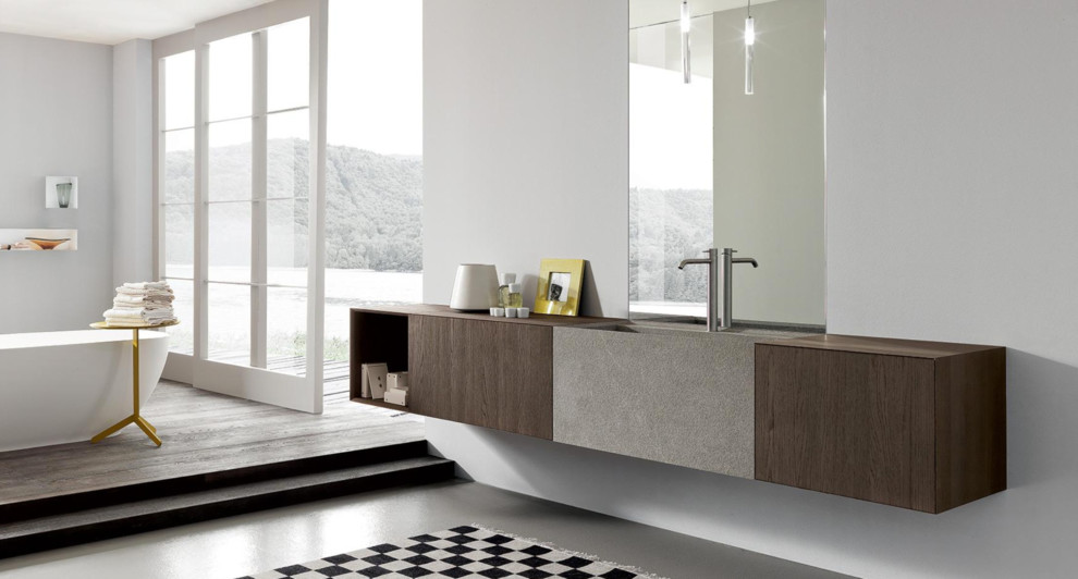 Foto de cuarto de baño minimalista con puertas de armario grises, paredes grises, lavabo integrado, encimera de madera y suelo marrón